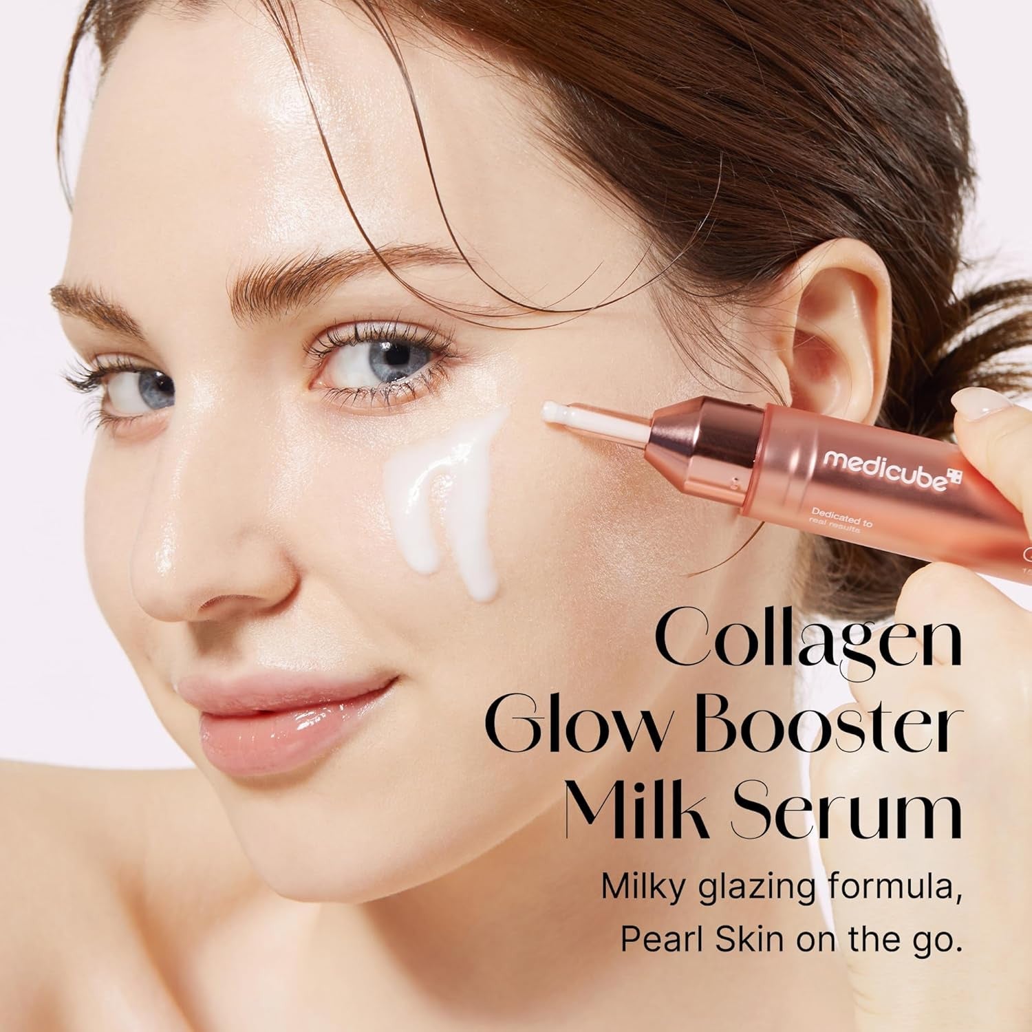 Woman applying Collagen Glow Booster Milk Serum to her face with a applicator.

